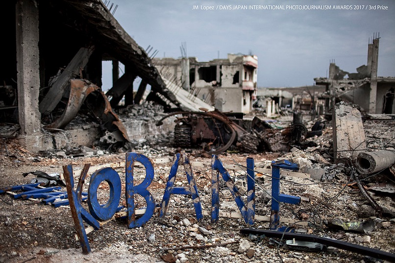 A sign with the name of the city is seen amidst the debris, in Kobane, Syria, on February 24, 2015. Kurdish forces with the help of an international coalition recaptured this town on the Turkish frontier after 132 days sieged by the jihadists of the Islamic State. (Photo by JM Lopez)